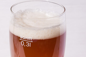 beer foam in glass. home made craft beer from light malt  on white background.  Ale or lager from pilsner malt