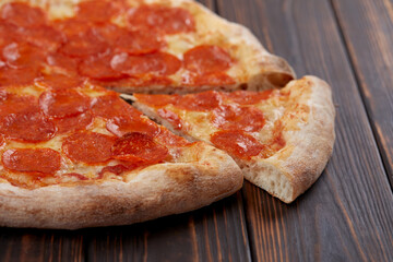 tasty pizza on the wooden background