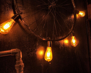 focused yellow light glass bulb and gradient light and cycle tire as a fixture
