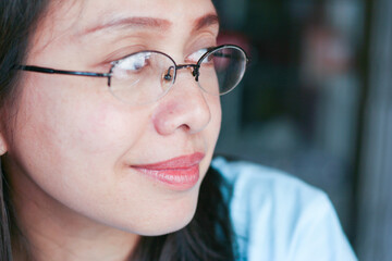 Asian woman wear glasses smiling