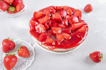 cheesecake with strawberry and fresh berries on gray table