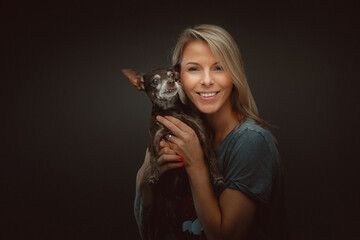 Young pretty woman with her Toy Terrier dog