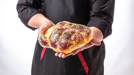 challah Jewish bread in man hands, homemade baking, traditional Jewish bread, Jewish pastries