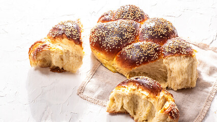 Close up traditional jewish bread brown challah on white background. Rustic concept