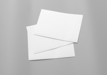 Poster white mock-ups paper isolated on gray background, Blank portrait paper A4. brochure, can use banners magazine products business texture.
