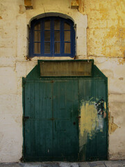 Old door and window in the historic city center of Valletta. Malta Island.