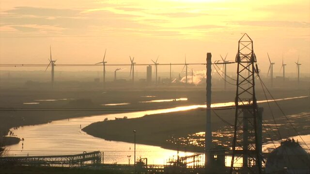 Wind turbines and renewable energy near Manchester sunset yellow sky