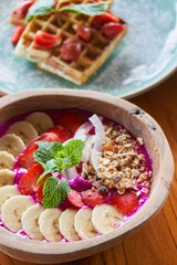   Breakfast style fruits bowl with cereal and belgian wafer