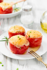 Tomatoes stuffed with rice and vegetables, baked with cheese . Vegetarian food.