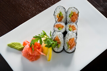 Sushi roll with salmon and shrimp tempura.