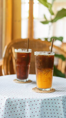 Iced americano coffee and orange juice in a cafe.