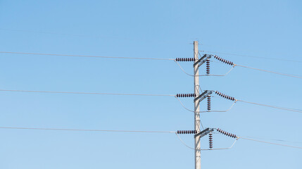 Electric pole and transformer on a blue sky.
