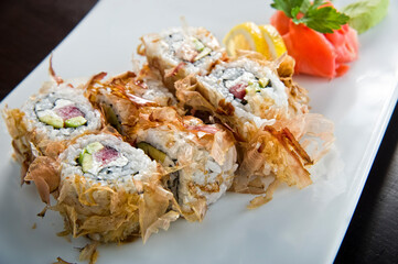 Sushi roll with salmon and shrimp tempura.