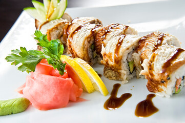 Sushi roll with salmon and shrimp tempura.