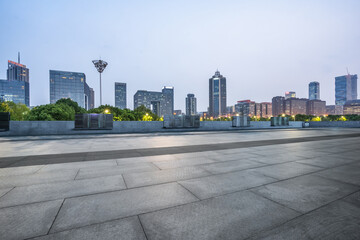night view of empty brick floor front of Panoramic skyline and buildings