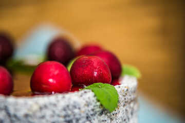 Delicious sweet poppy cake with different fresh cherry. Sweet homemade cake. Closeup