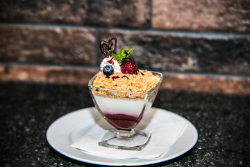 Delicious sweet dessert with different fresh fruit and cream. Closeup.