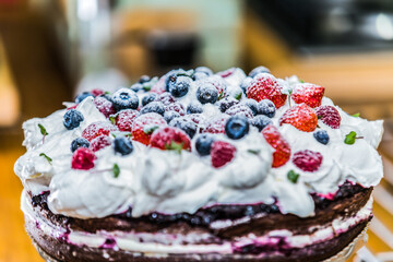 Delicious sweet cake with different fresh fruit. Sweet homemade cake. Closeup.