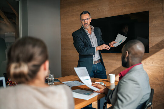 Manager going over paperwork during a boardroom meeting
