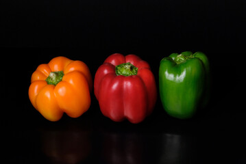 red yellow green pepper on a black table