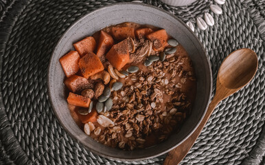 Chocolate smoothie bowl with papaya and granule topping. Healthy food. Vegetarian breakfast