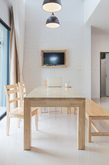 computer laptop on the wood table with a cup of coffee in living room