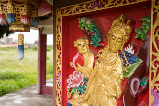Detail images of colorful Taoist temple with dragons and gods to protect farmers and farms in rural part of Hsinchu
