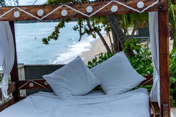 Woodern four poster bed overlooking the beach