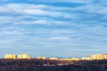 Fototapeta premium dark blue clouds over urban park in Moscow city at spring sunset