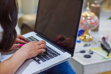 Fototapeta na wymiar female hands typing on a keyboard, female hands typing on a laptop, young woman working on laptop
