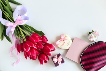 A bouquet of pink tulips with gifts on a white background . Holiday concept