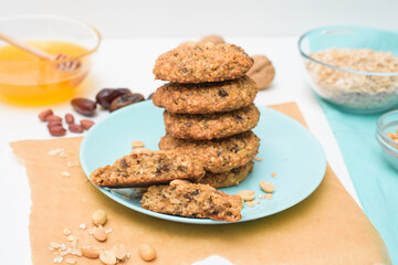 homemade oatmeal cookies with dates, peanuts, coconut shavings, macro close-up. broken cookies in the foreground. space for text.