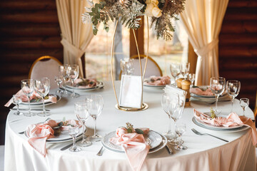 Festive table setting with wine glasses, fresh flowers and tables with number