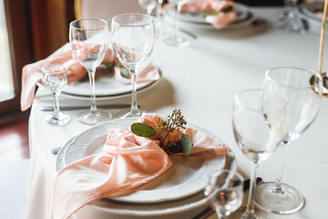 Side view festive table setting with empty wine glasses and two plates