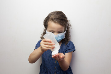 young girl using sanitizer hand gel 