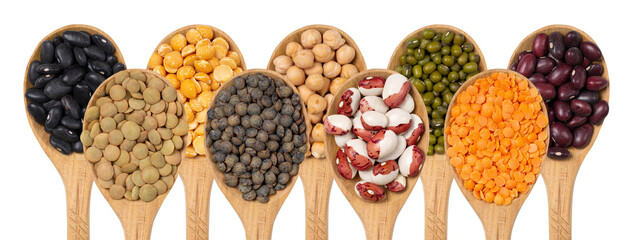 Collection of legumes in wooden spoons on a white background top view. An isolated set of beans,...