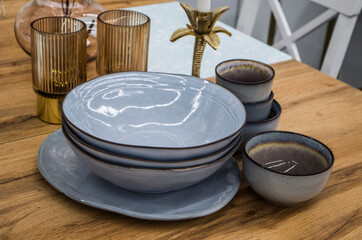 Still life with plates and cups in the style of Hughes.