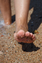 Walk on the sand, on the beach, on the beach. Health. Close-up of a woman's legs.