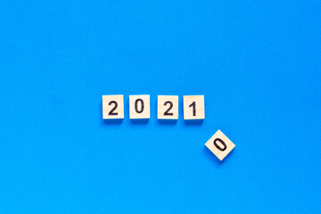 Happy New year written in wooden letters on a blue background. Happy new year 2021. flat layout. space for text. top view.