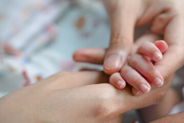 Close up photo for the hand of the baby with long nails.