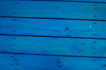 Background from boards painted with blue paint, located horizontally.