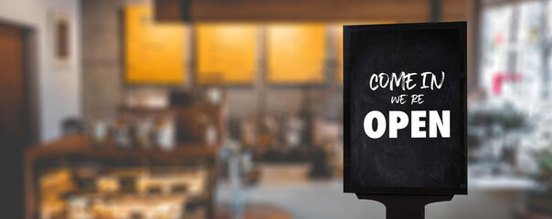 Come in We’re Open’ on cafe waiter standing in front of coffee shop vintage retro sign Open...