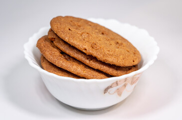 A stack of Butter Crunch Cookies served in a small porcelain bowl