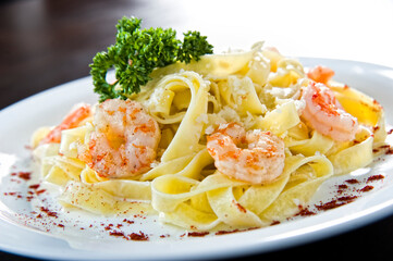 Italian fried salmon and penne rigate with creamy spinach alfredo pasta sauce