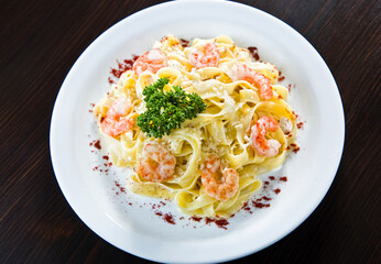 Italian fried salmon and penne rigate with creamy spinach alfredo pasta sauce