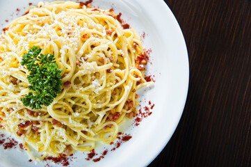 Italian fried salmon and penne rigate with creamy spinach alfredo pasta sauce
