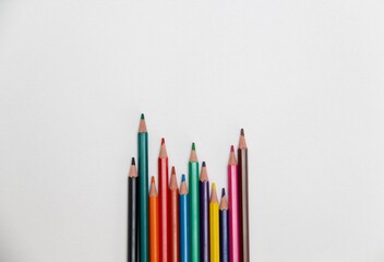 colored pencils on a white background