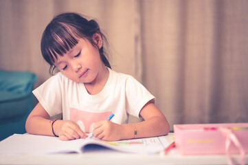 Naklejka premium School Home work concept,Asian children doing school home work drawing during the COVID-19 quarantine. Coronavirus isolation. online studying from home