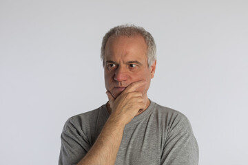 Mature adult in isolated contemplation on white background.