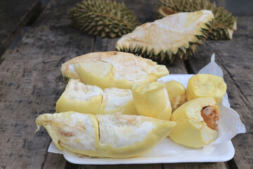 Durian riped and fresh with yellow colour on wooden table.